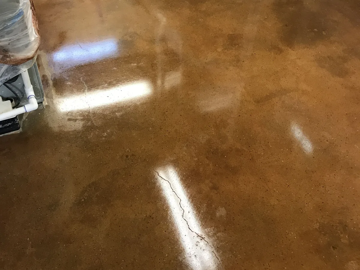 Brown stained and sealed concrete floor with a high gloss finish, polished concrete floors