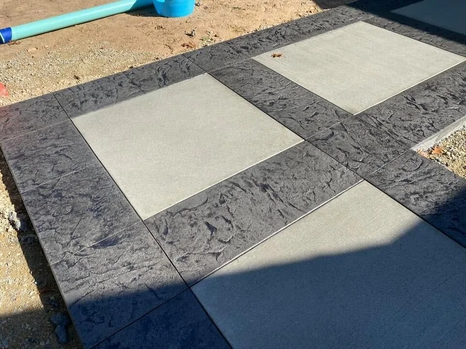 Stamped concrete bands framing smooth broom finish squares, stamped concrete